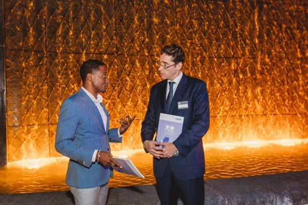 Two professionals in conversation at an event
